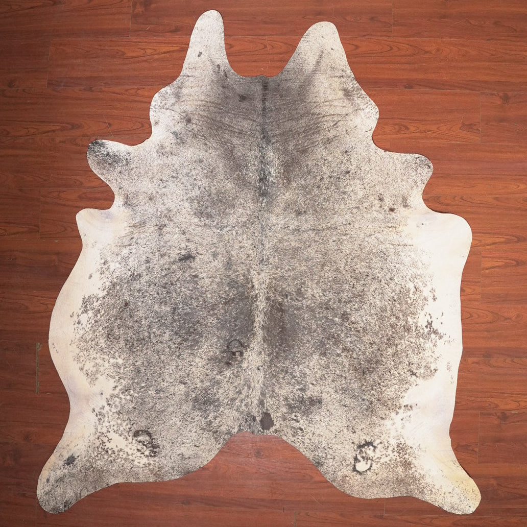 cow hide rug on wood floor