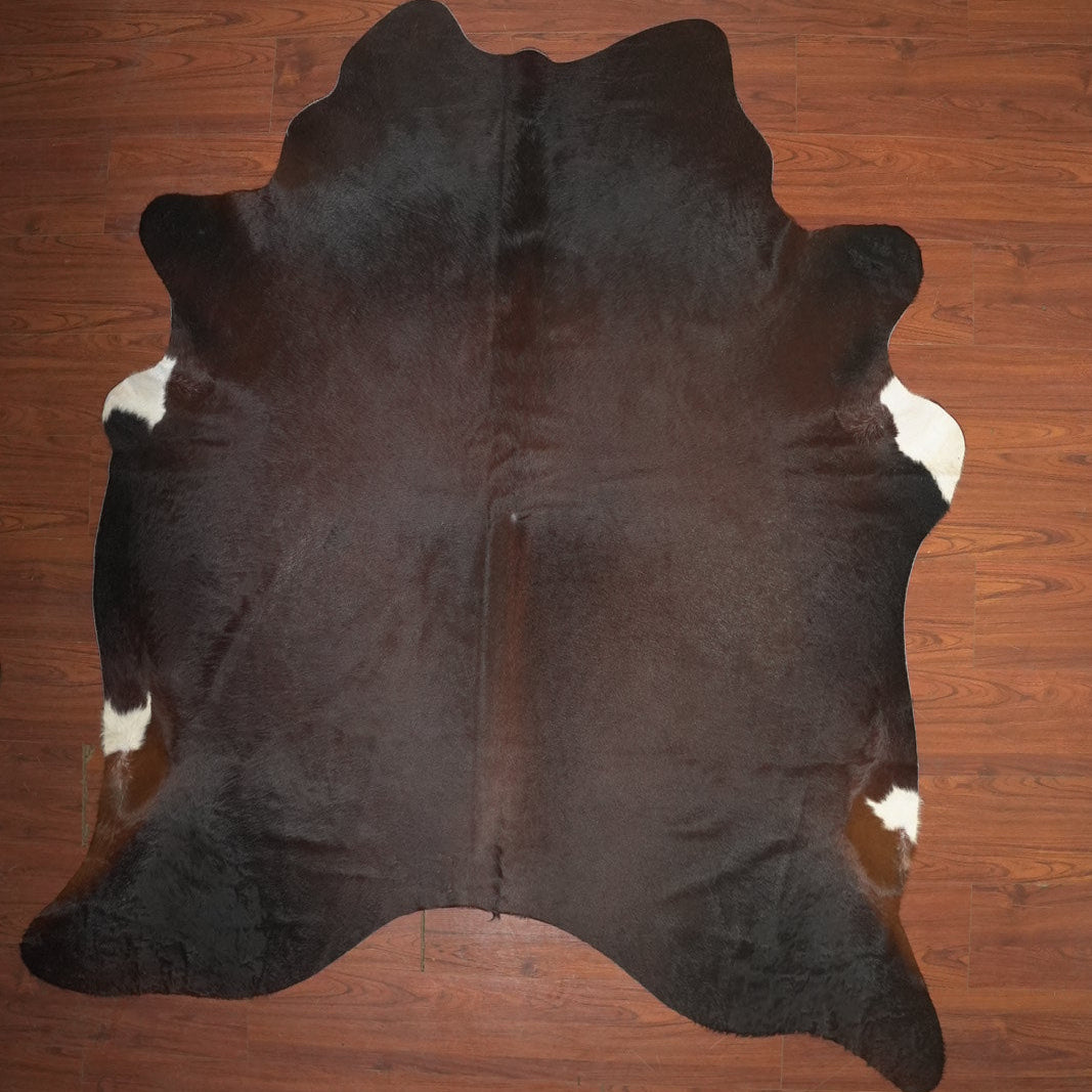 Brown cowhide rug on a wooden floor