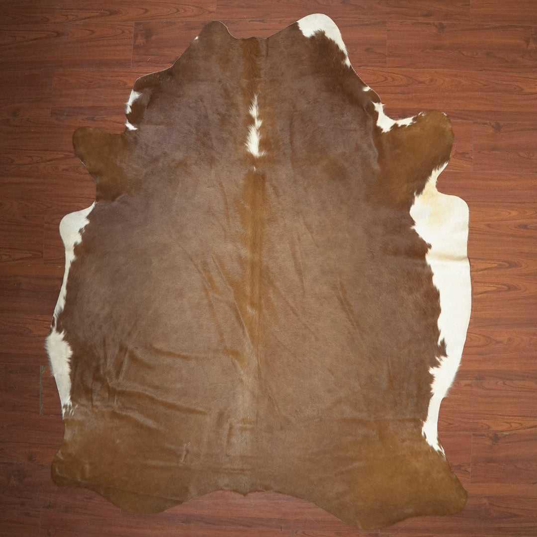Brown cowhide rug on a wooden floor