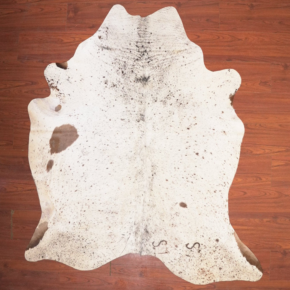 Cowhide rug on a wooden floor