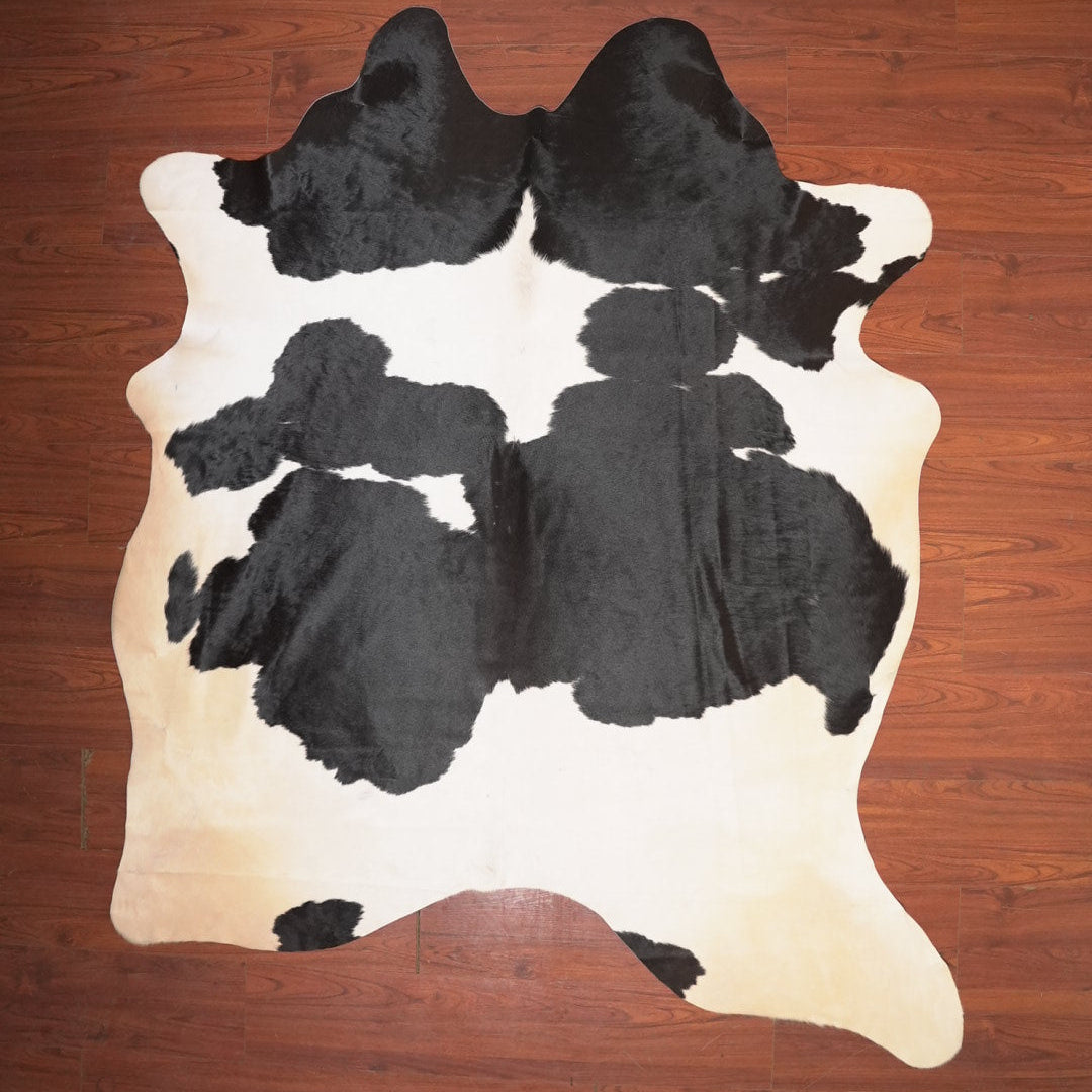 Cow print rug on a wooden floor