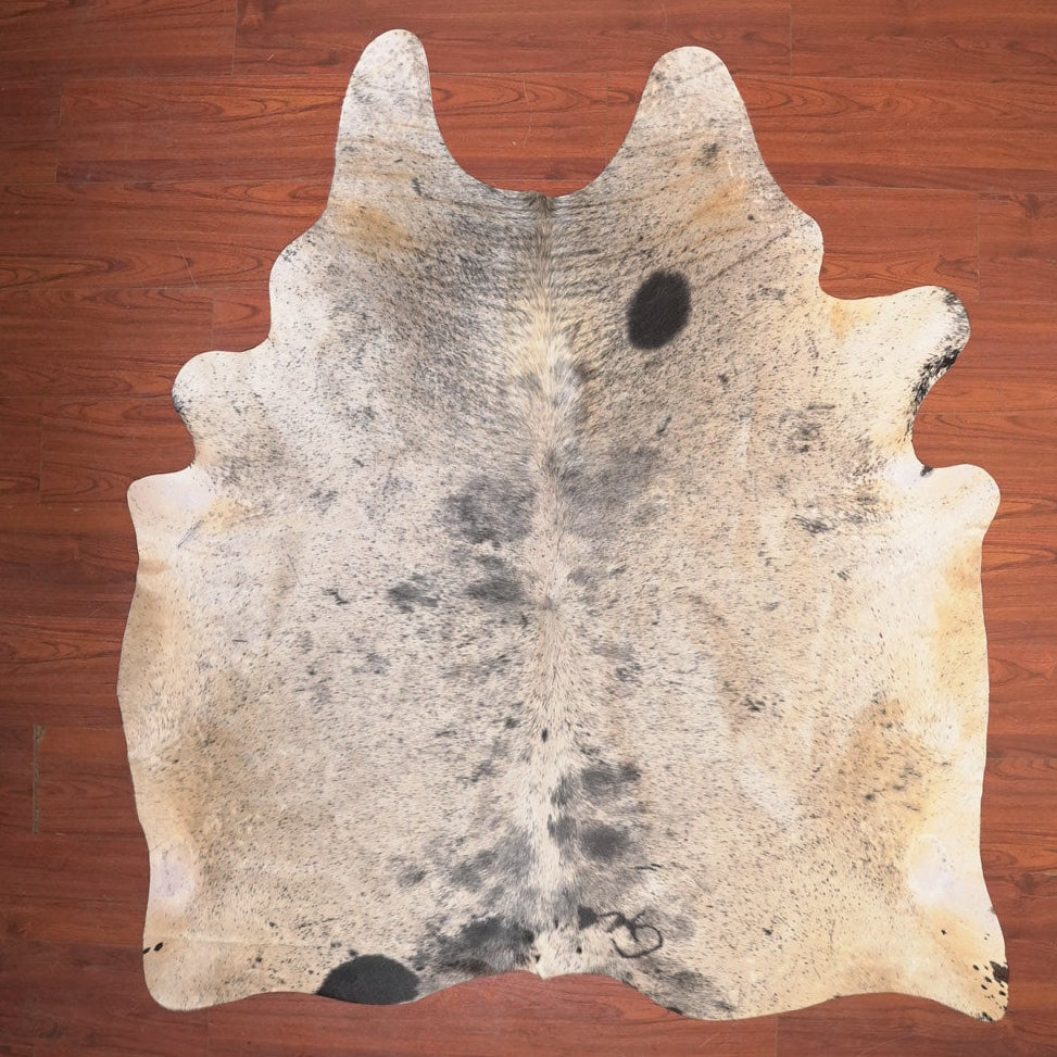 cow hide rug on wood floor