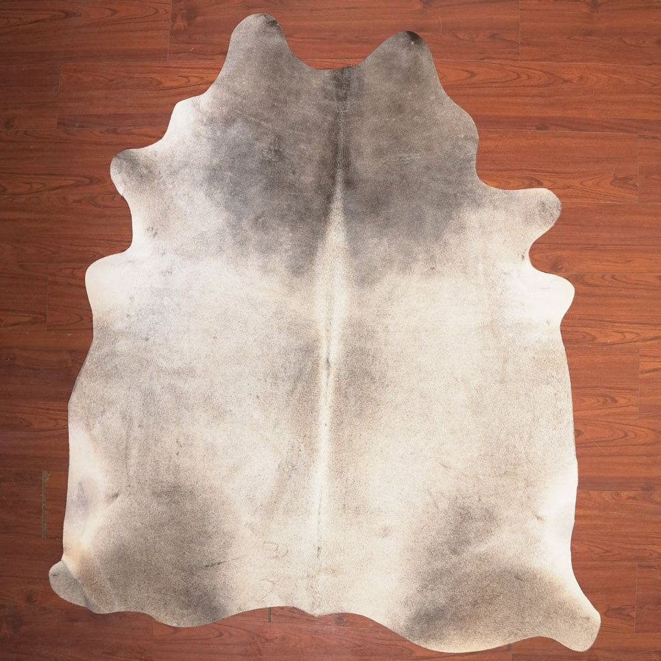 Cowhide rug on a wooden floor
