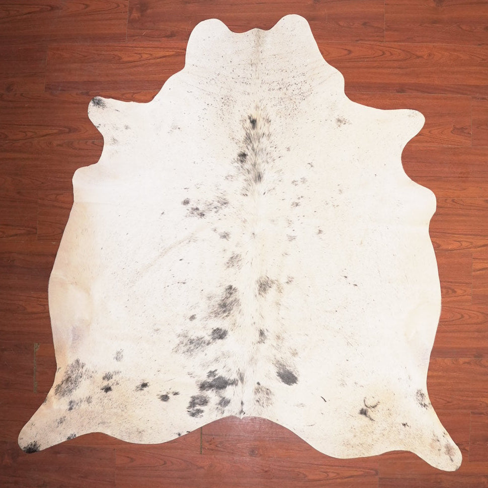 cow hide rug on wood floor