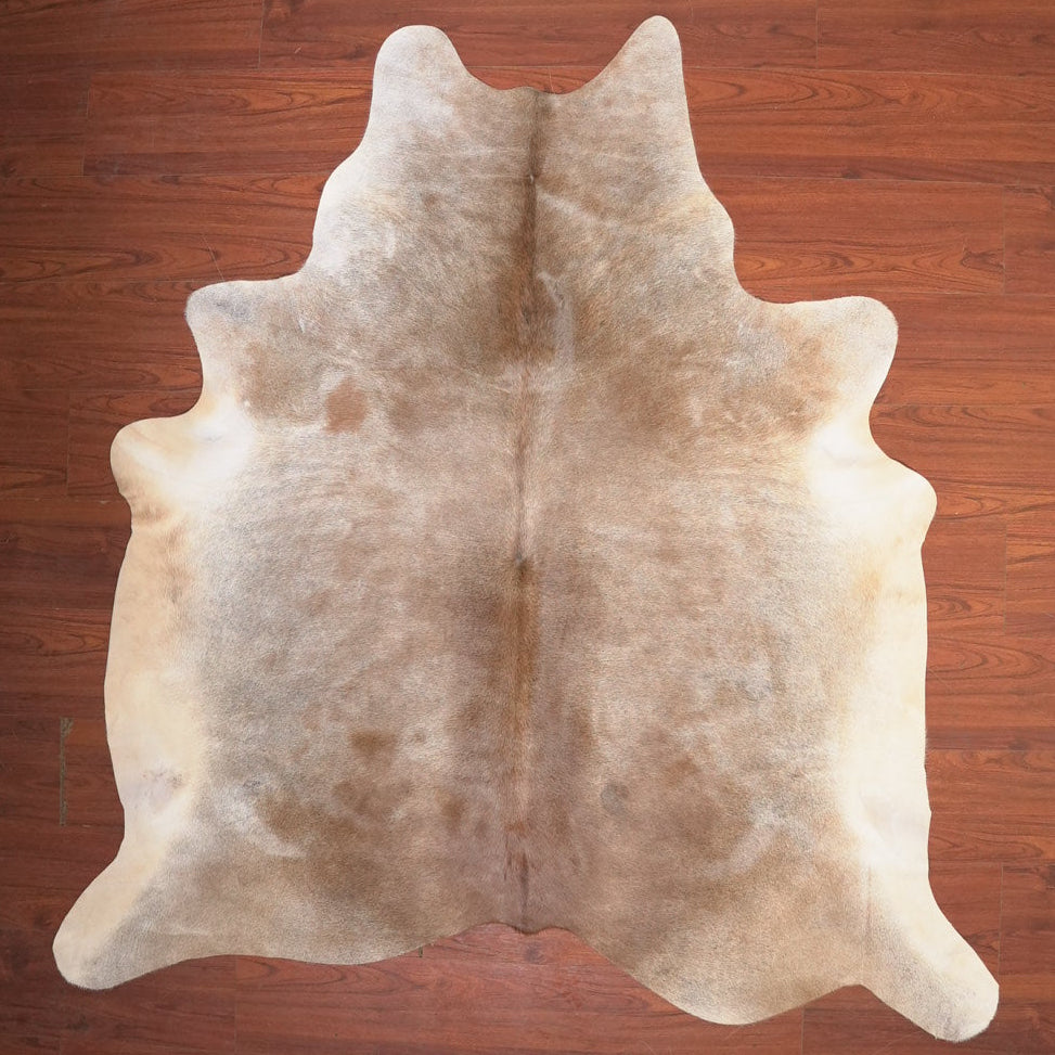 cow hide rug on wood floor