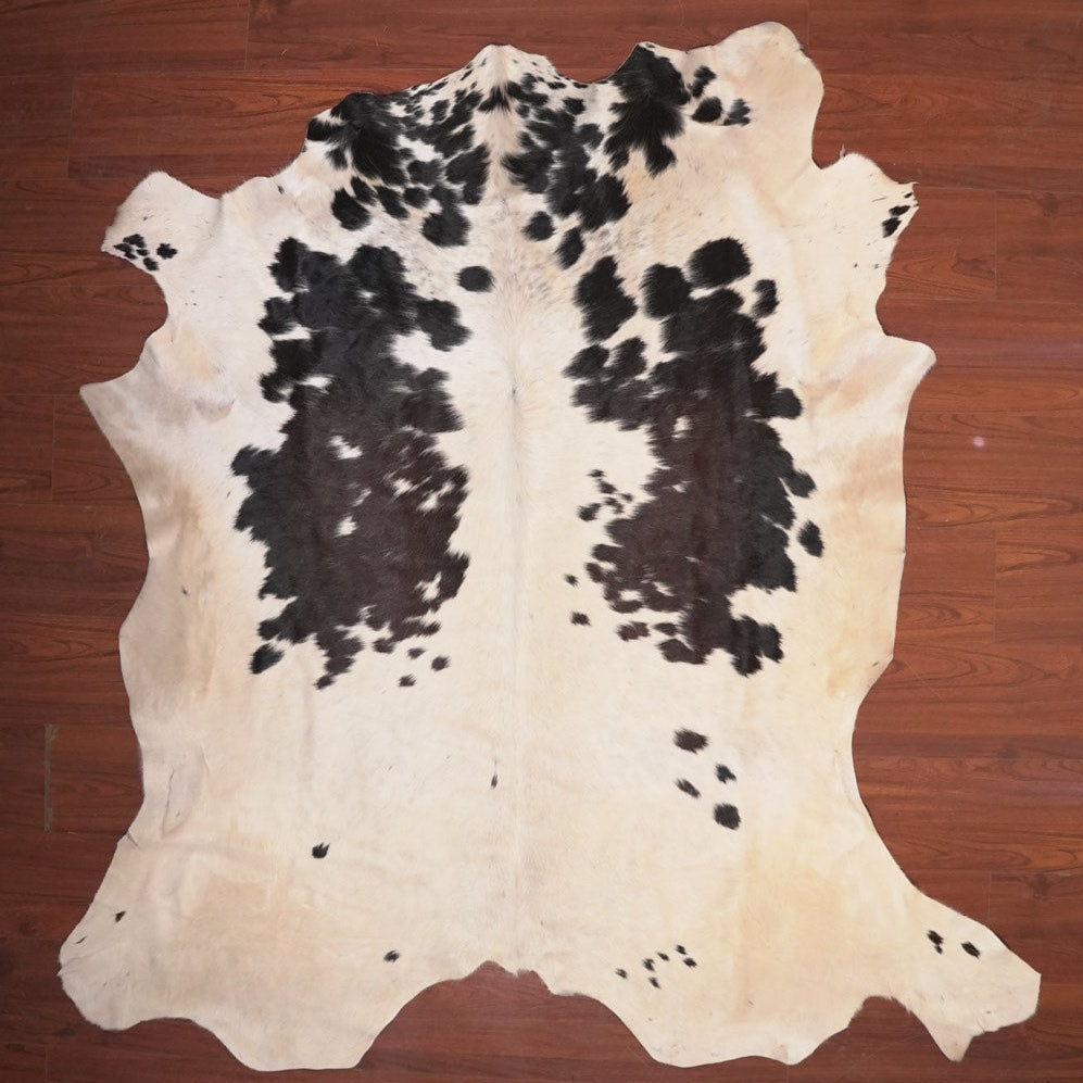 cow hide rug on wood floor