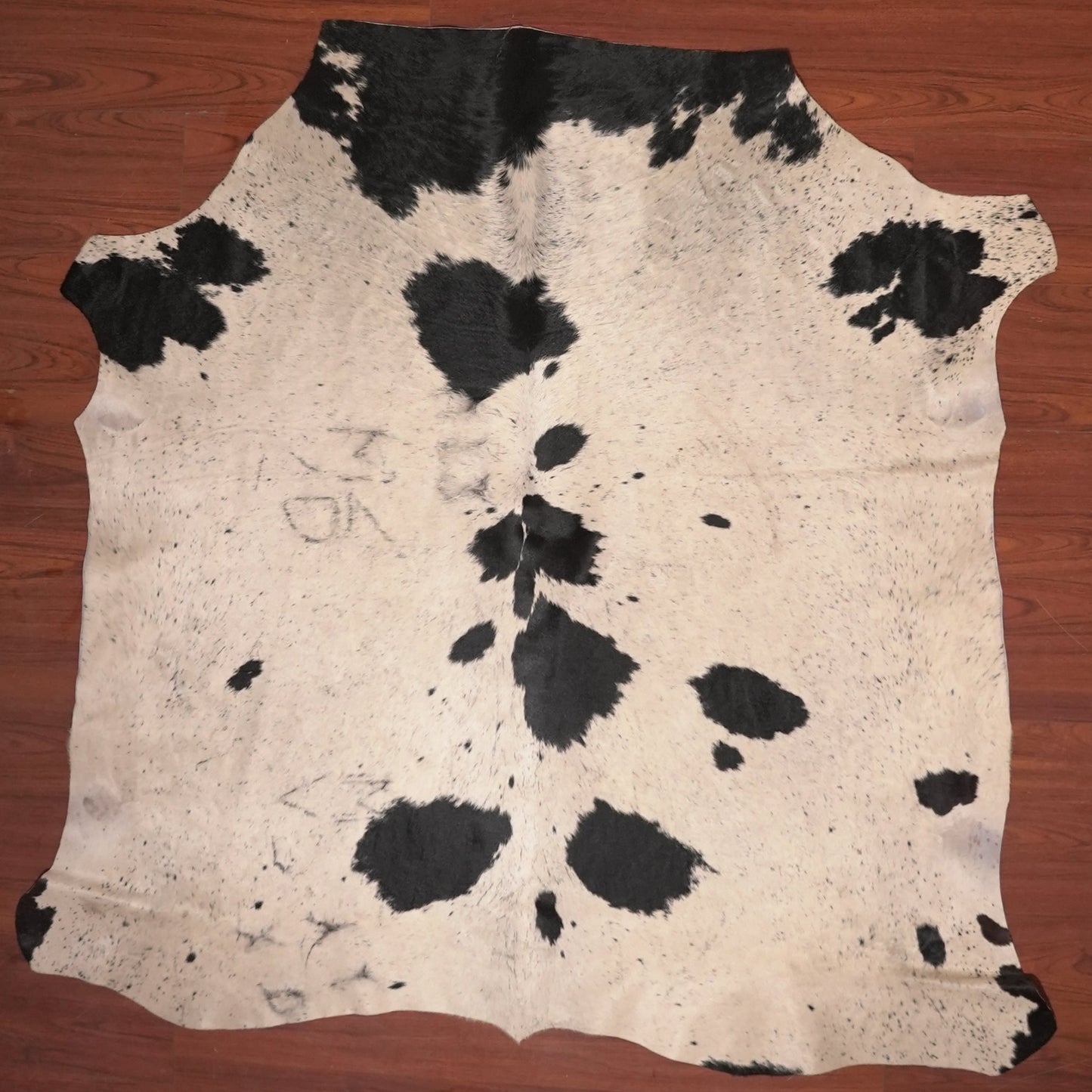 cow hide rug on wood floor