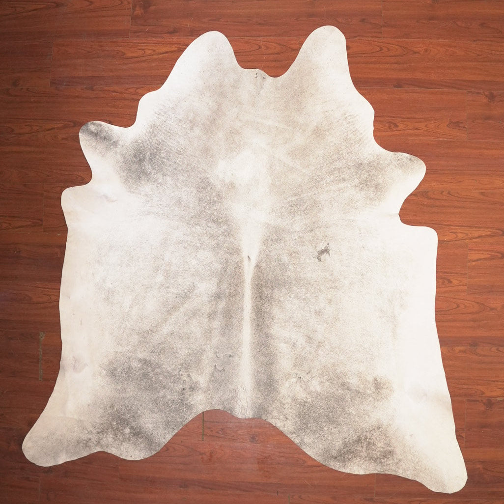 cow hide rug on wood floor