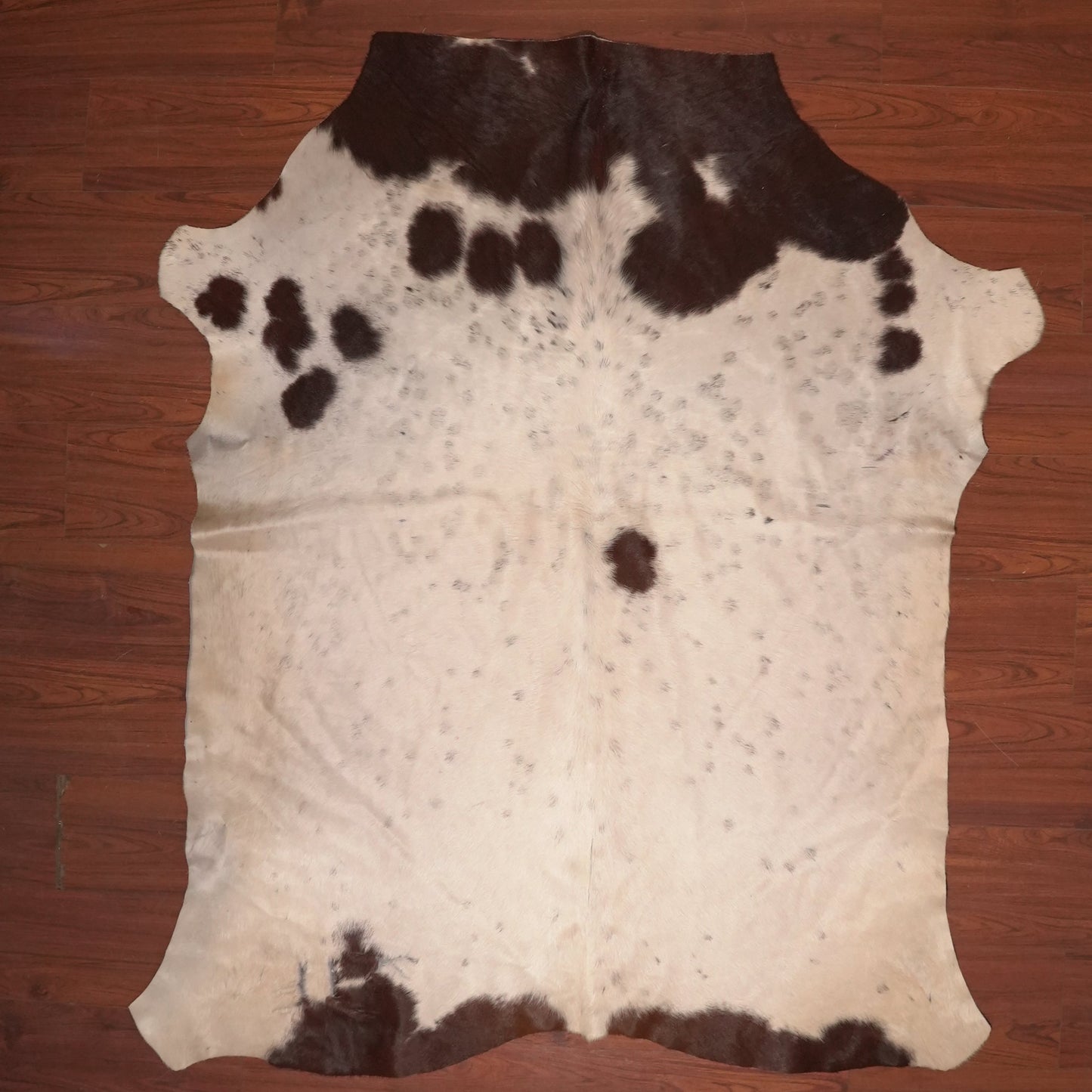 cow hide rug on wood floor