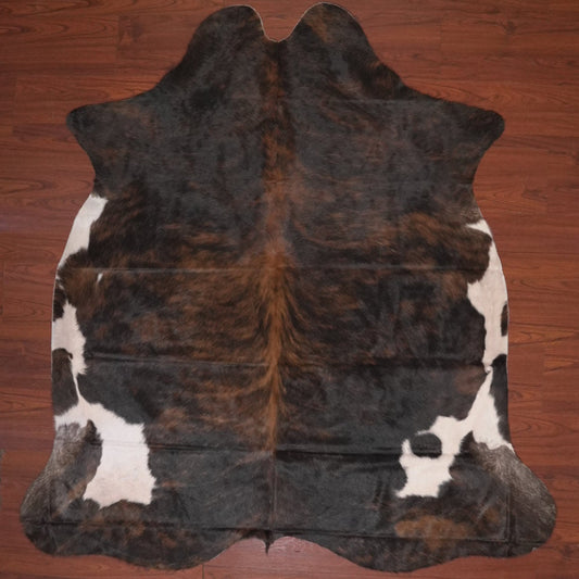 cow hide rug on wood floor