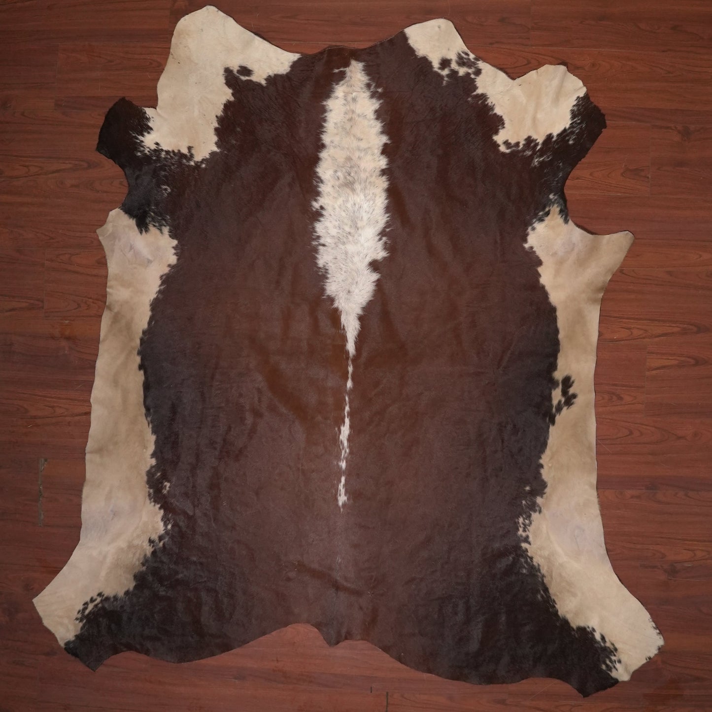 cow hide rug on wood floor