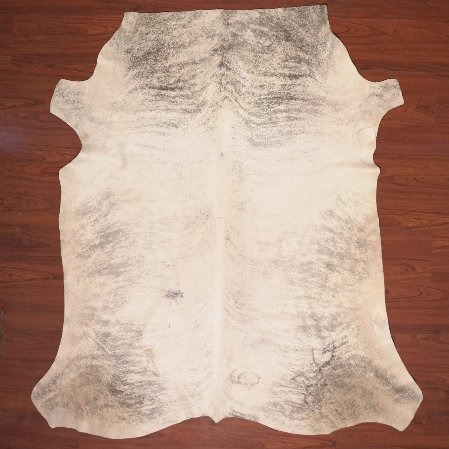 cow hide rug on wood floor