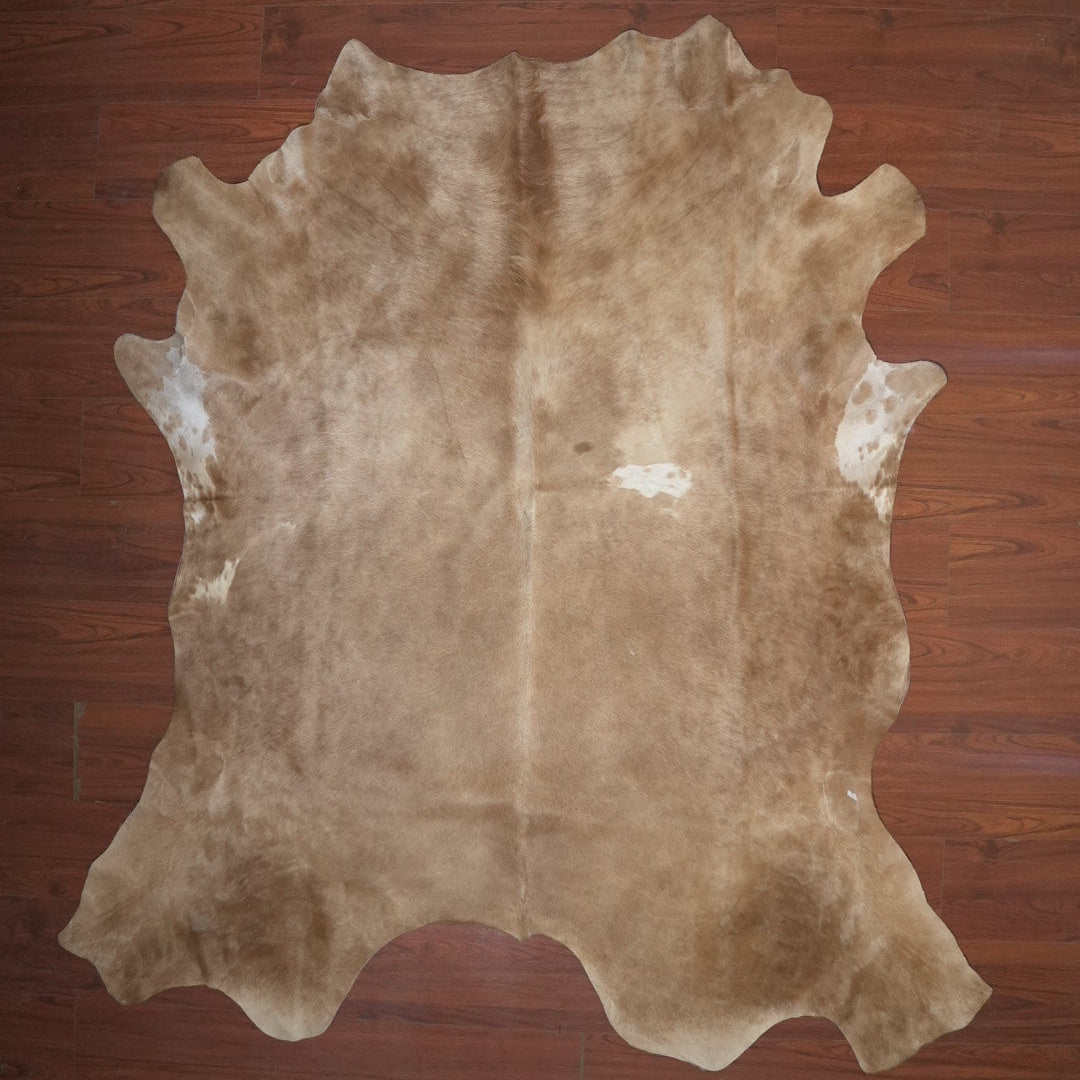 cow hide rug on wood floor