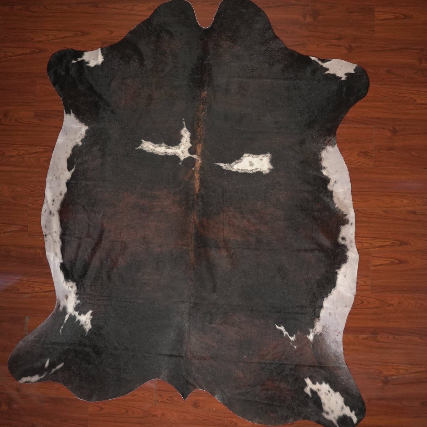 cow hide rug on wood floor