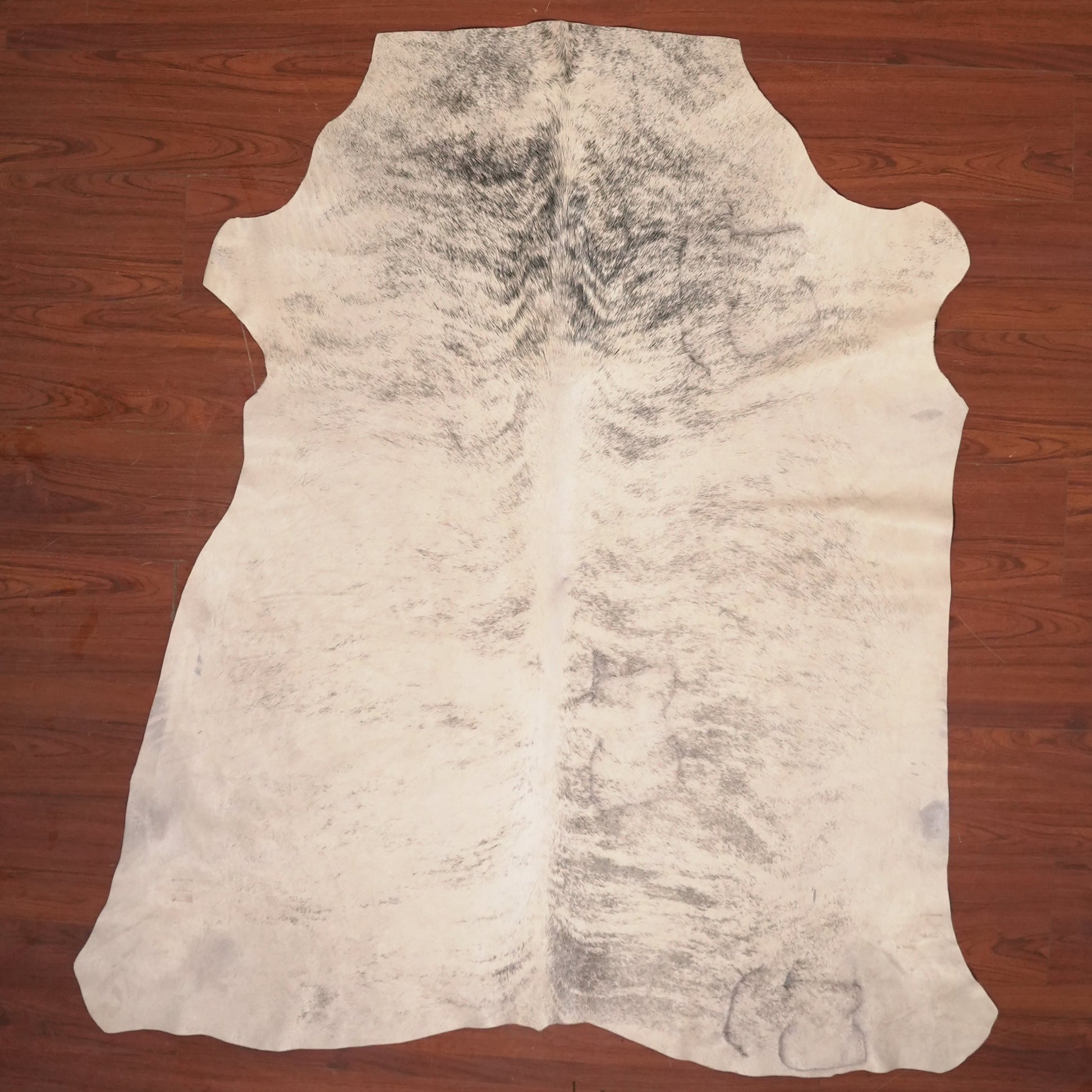 cow hide rug on wood floor