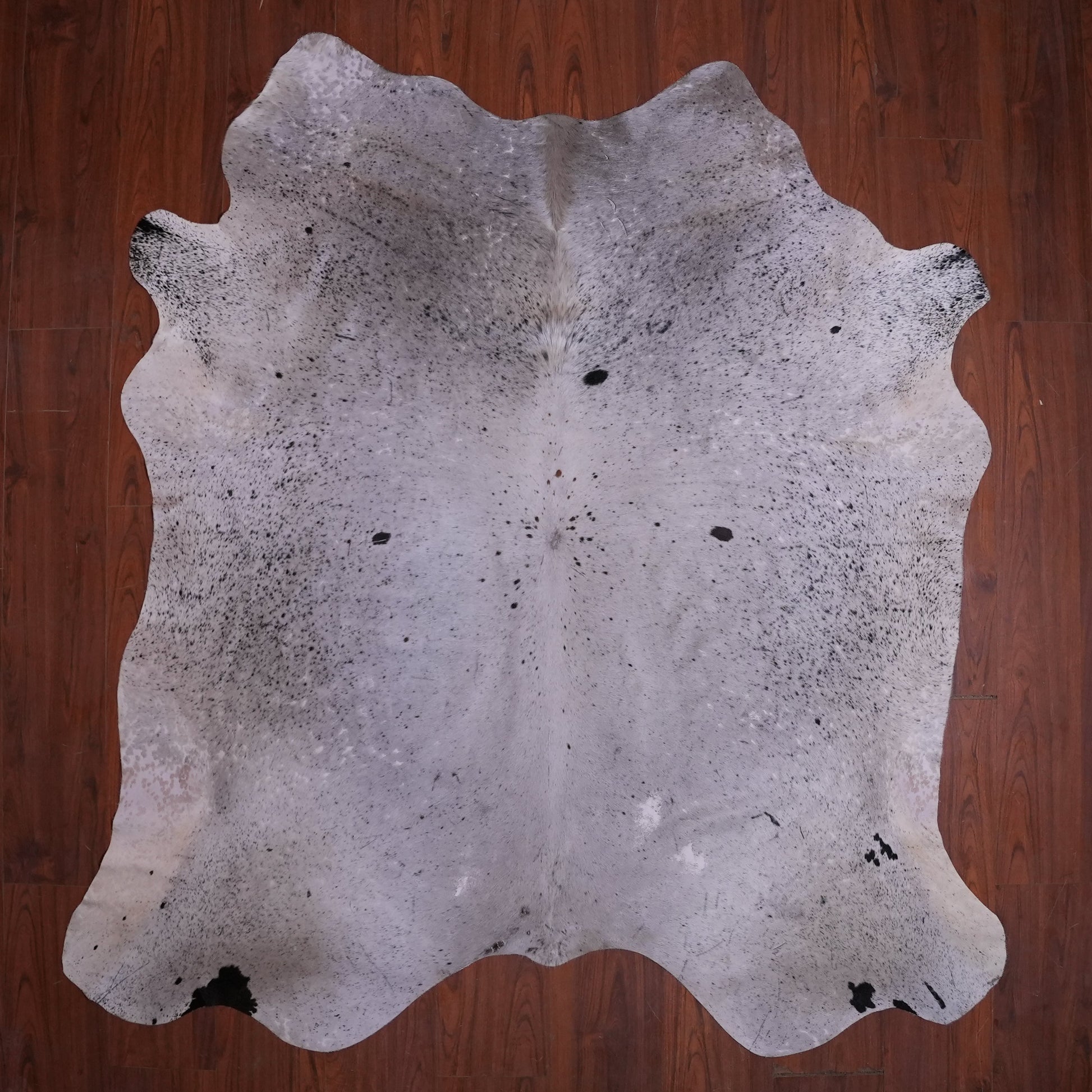 Cowhide rug on a wooden floor