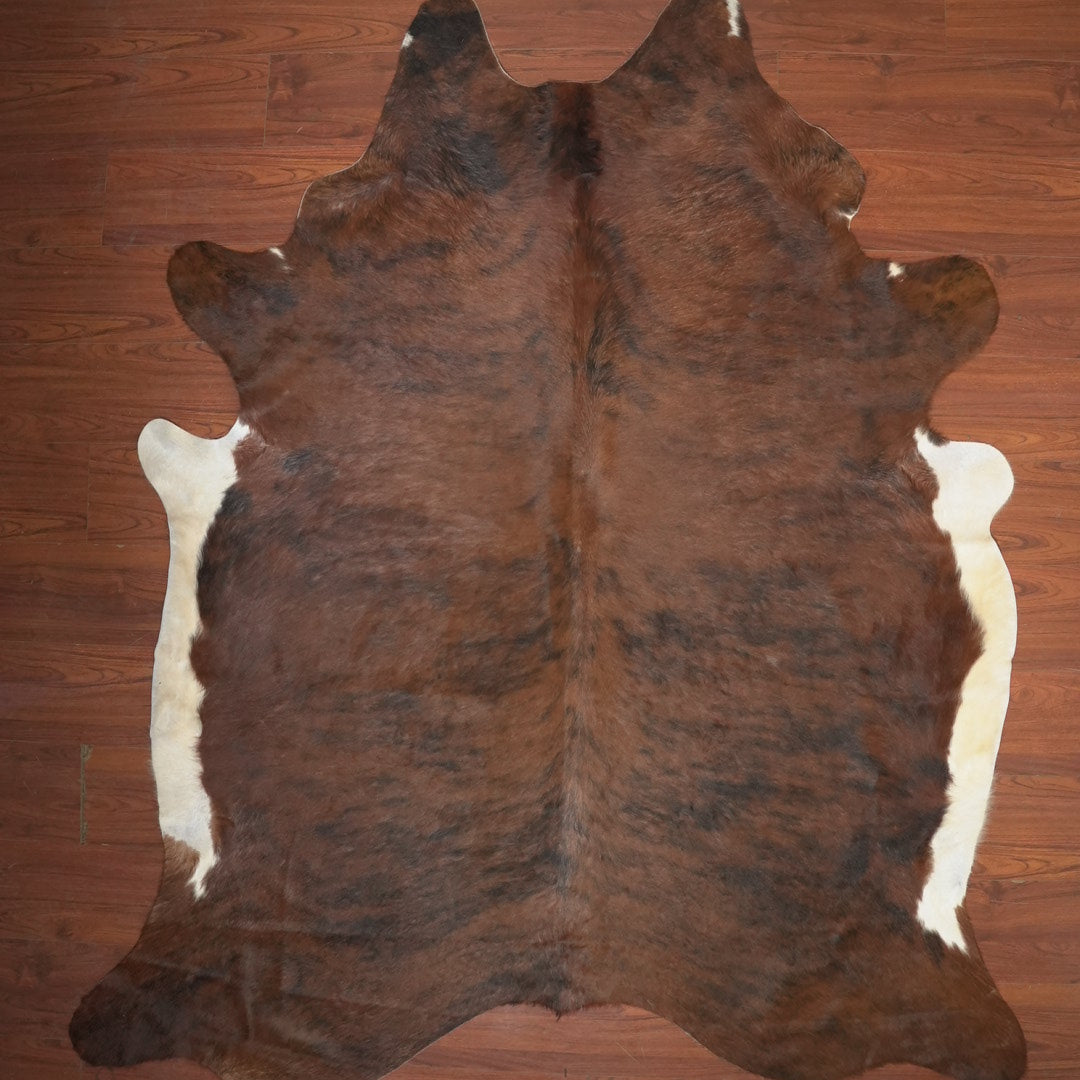 cow hide rug on wood floor