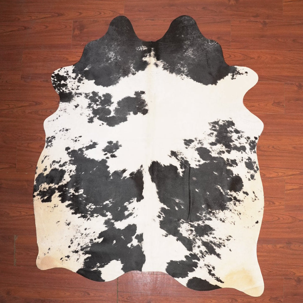 cow hide rug on wood floor