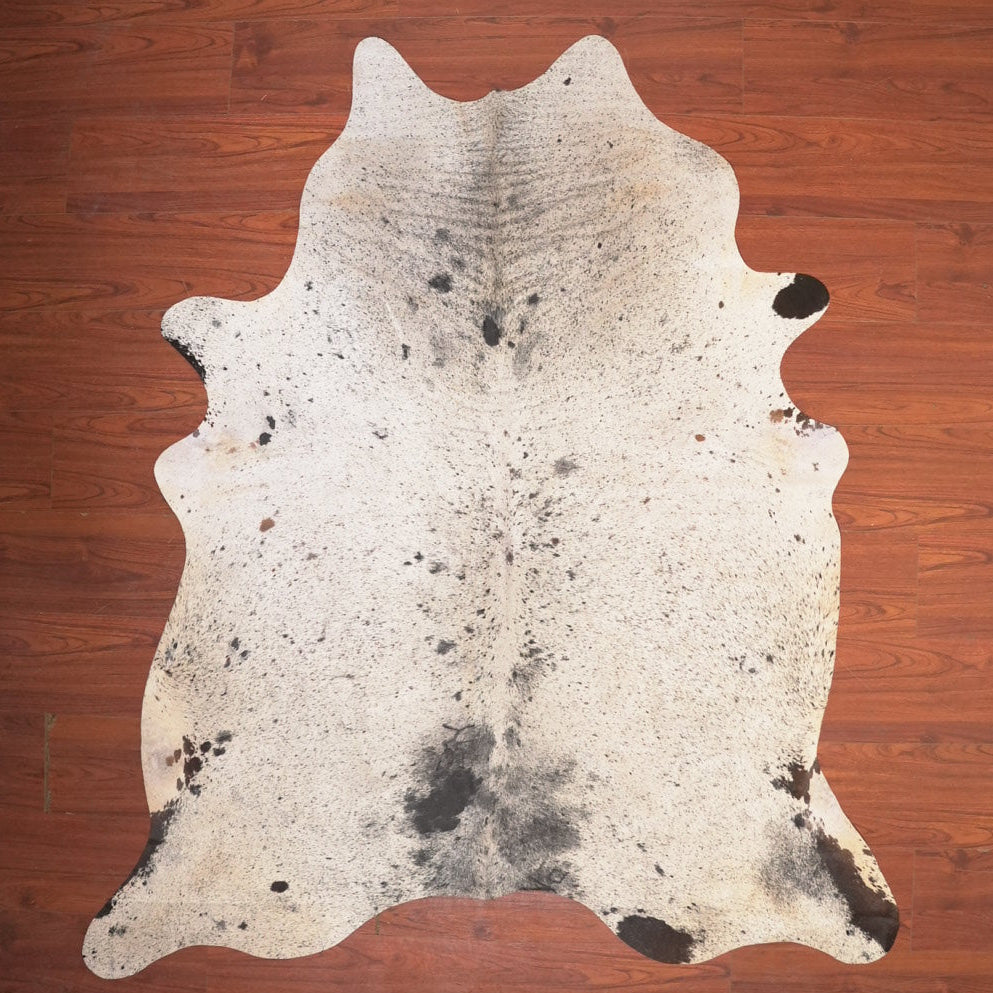 cow hide rug on wood floor