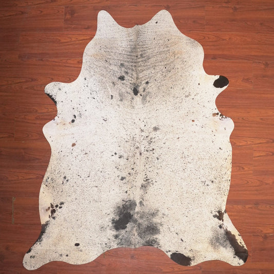 cow hide rug on wood floor