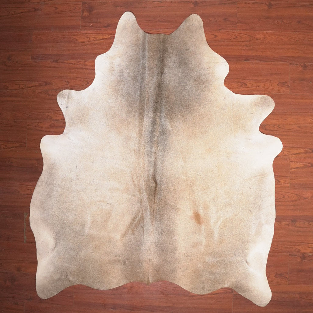 Cowhide rug on a wooden floor