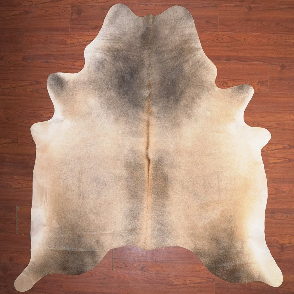 Cowhide rug on a wooden floor