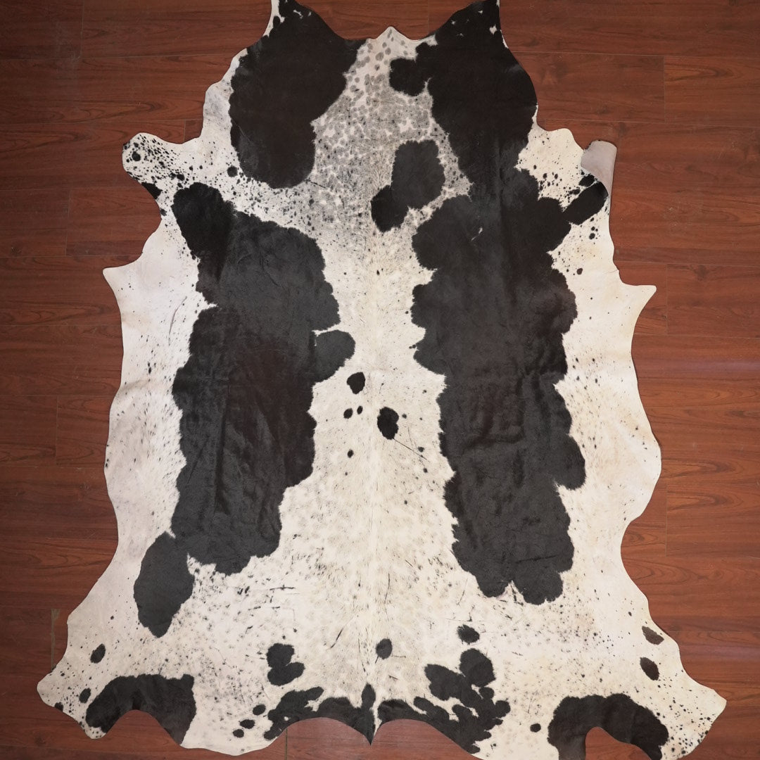 cow hide rug on wood floor