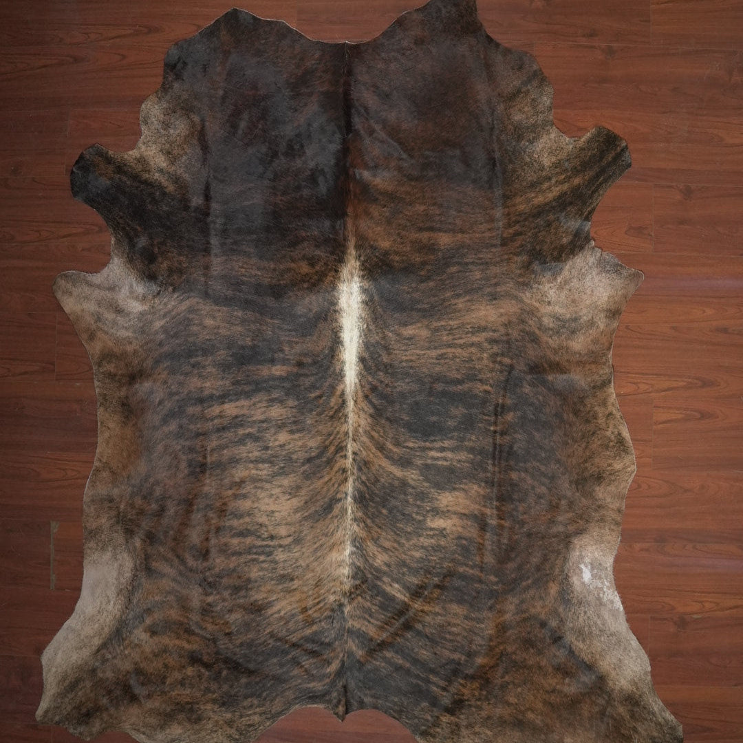 cow hide rug on wood floor