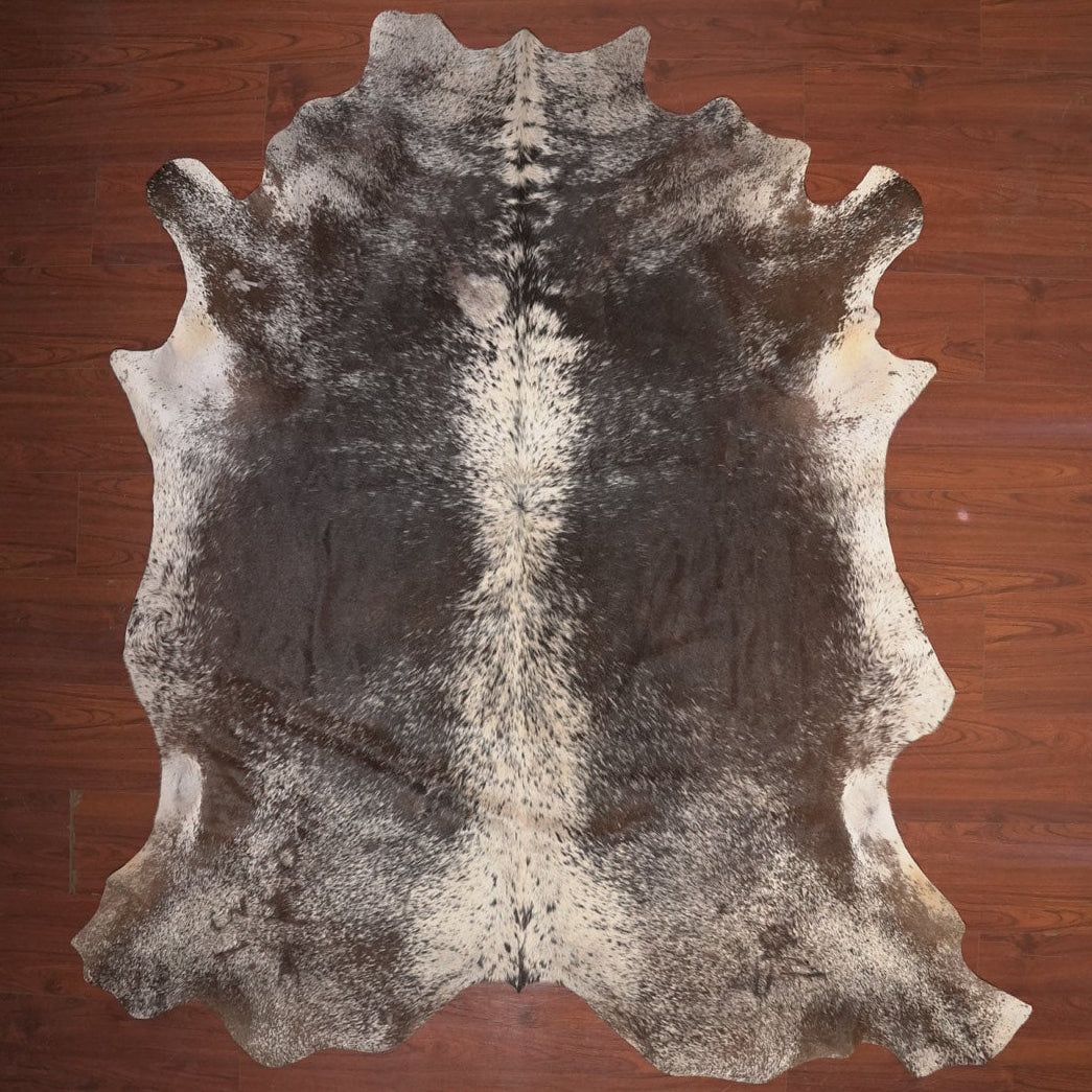 cow hide rug on wood floor