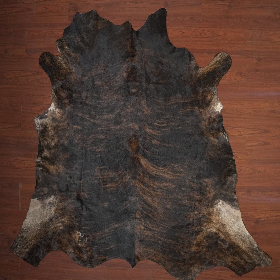 cow hide rug on wood floor