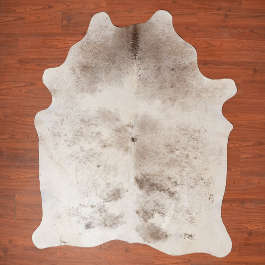 Cowhide rug on a wooden floor