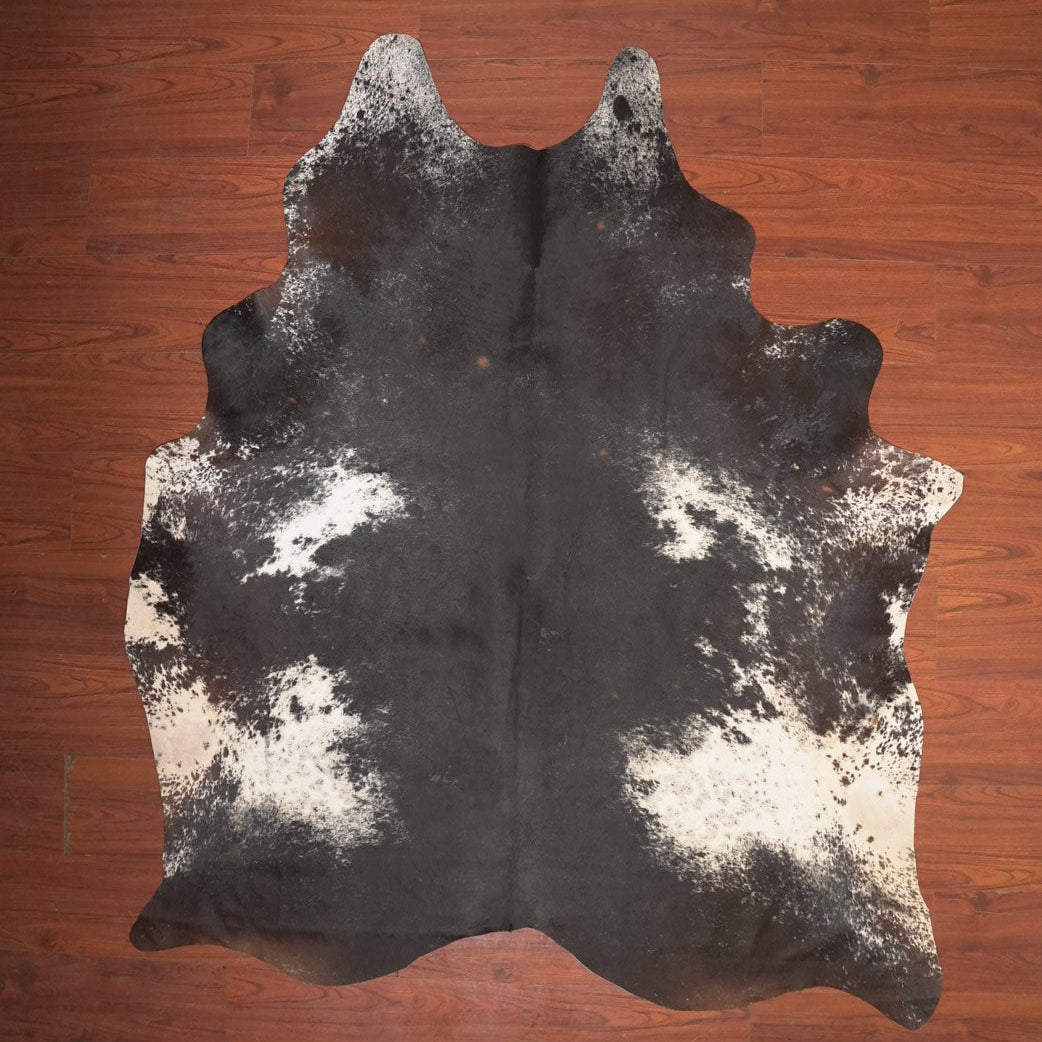 cow hide rug on wood floor