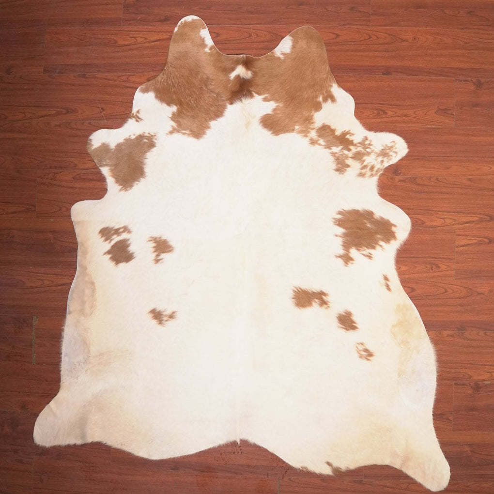 cow hide rug on wood floor