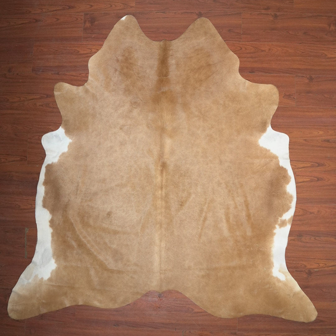 Brown cowhide rug on a wooden floor