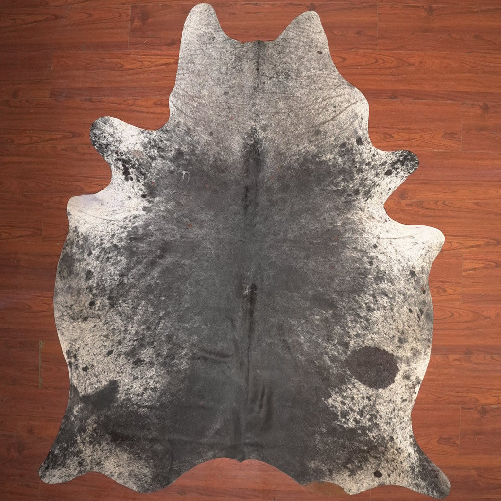 cow hide rug on wood floor