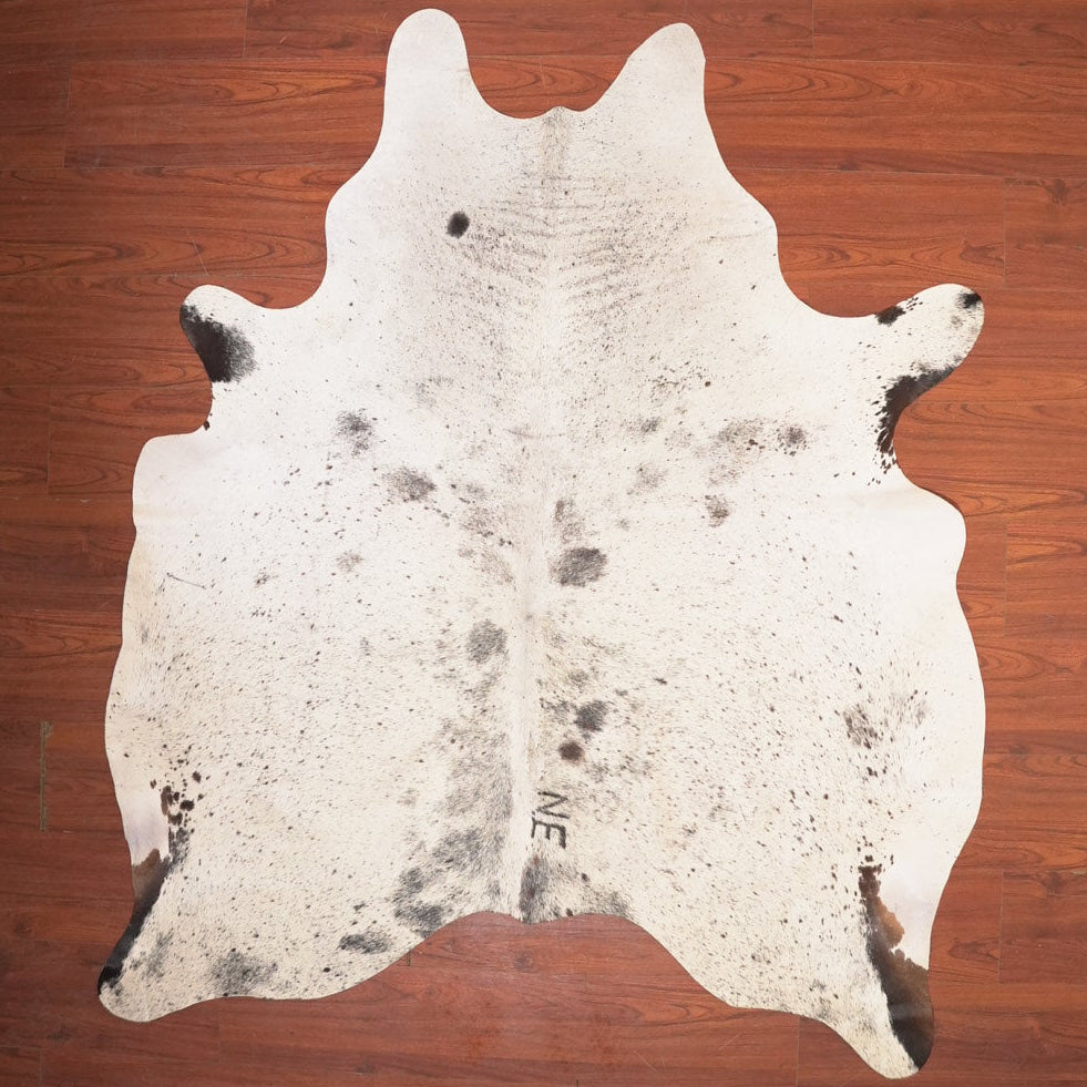 cow hide rug on wood floor