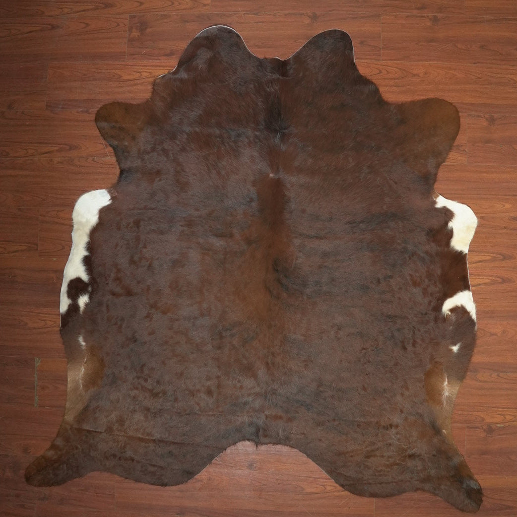 Brown cowhide rug on a wooden floor