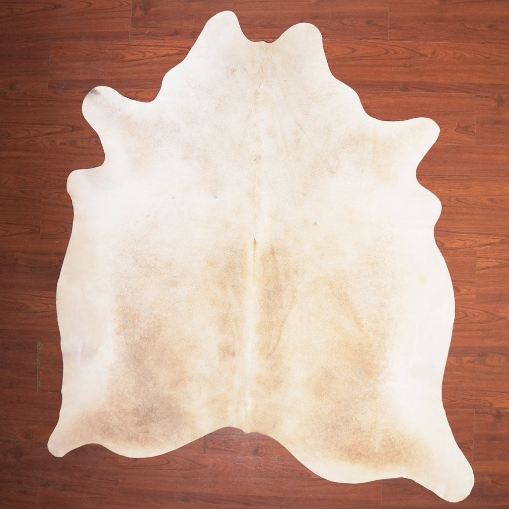 cow hide rug on wood floor