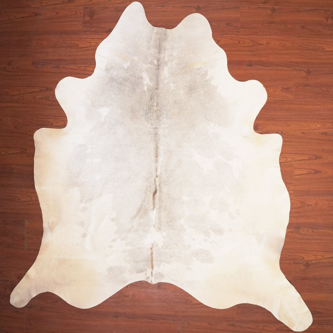 cow hide rug on wood floor