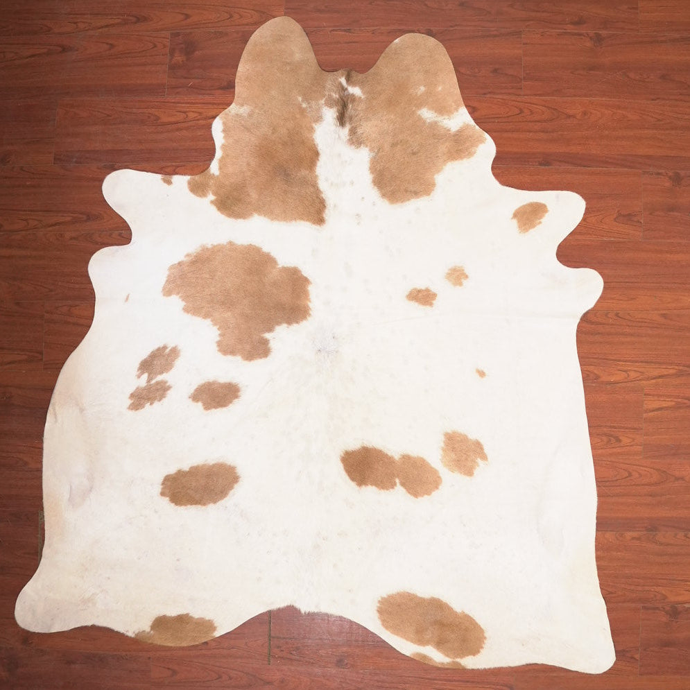 cow hide rug on wood floor