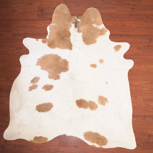 cow hide rug on wood floor