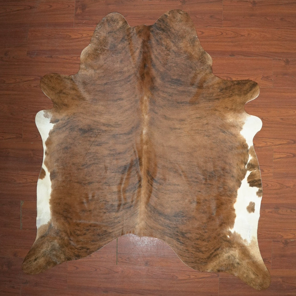 cow hide rug on wood floor