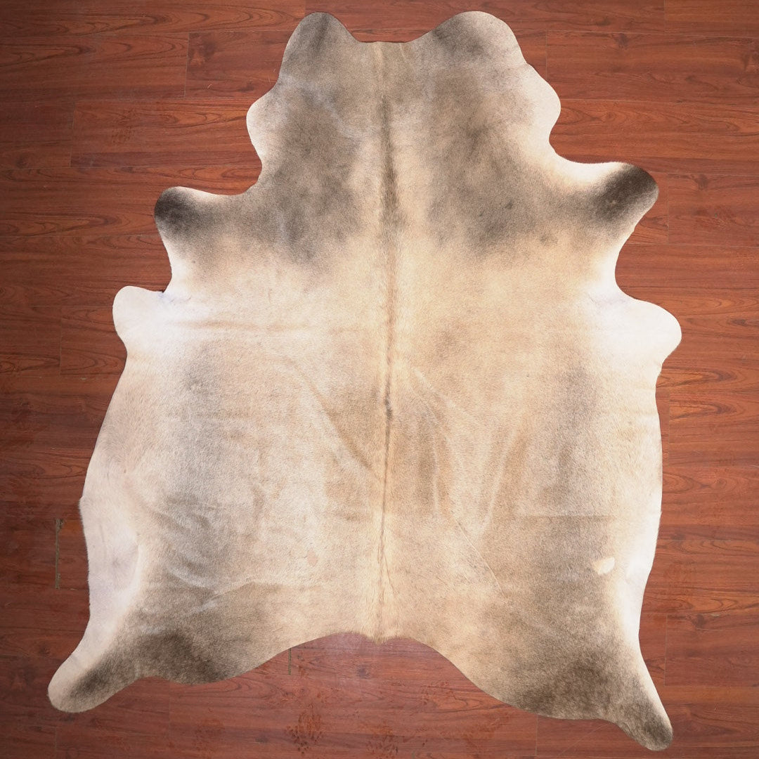 cow hide rug on wood floor