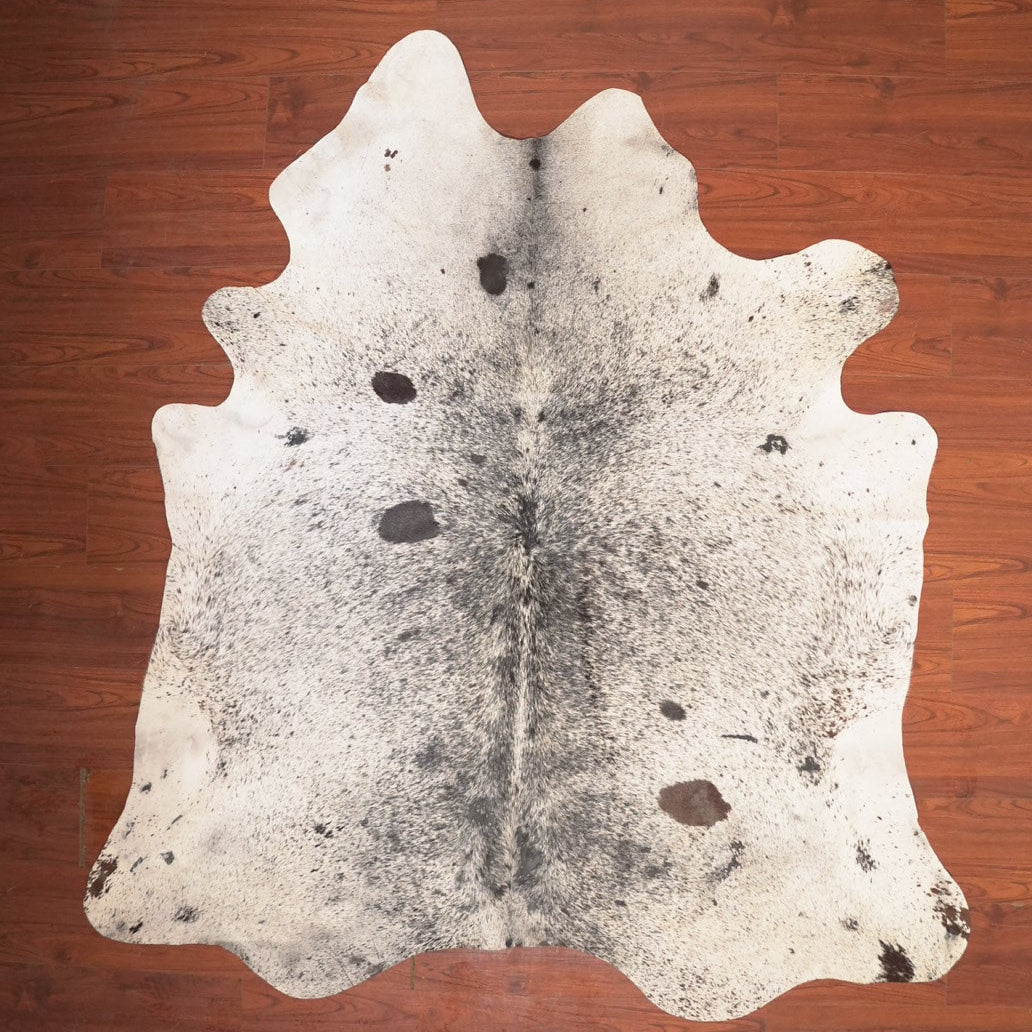cow hide rug on wood floor
