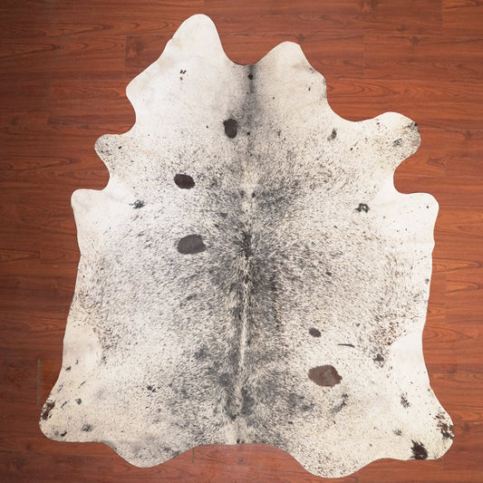 cow hide rug on wood floor