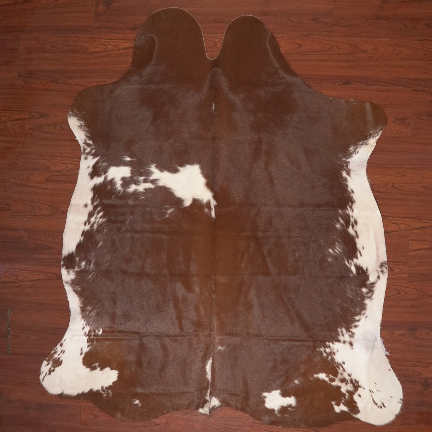 cow hide rug on wood floor