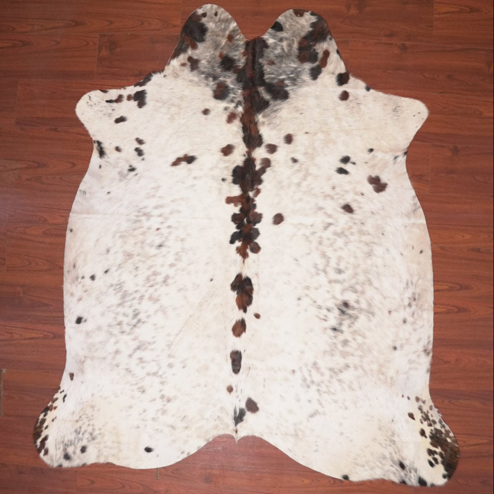 cow hide rug on wood floor