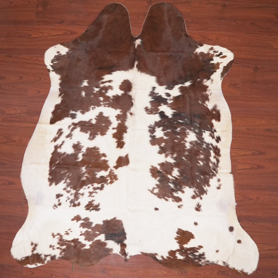 cow hide rug on wood floor
