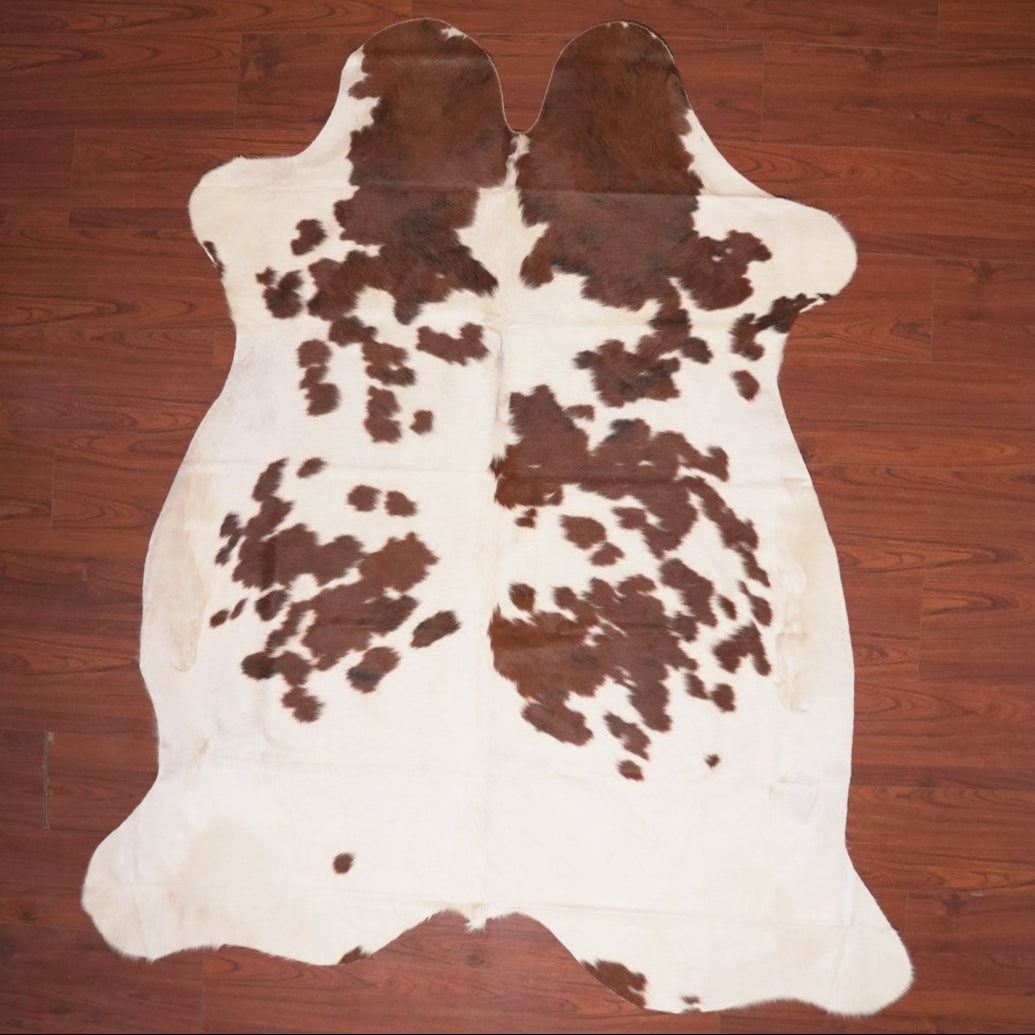 cow hide rug on wood floor