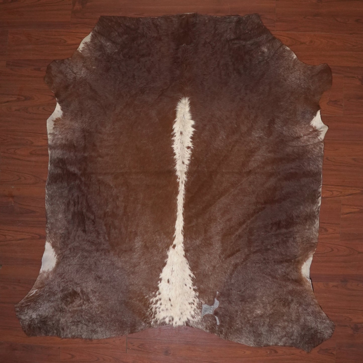 cow hide rug on wood floor